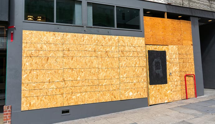 Exterior of a building with boarded-up entrance