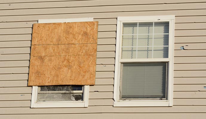 Multifamily residential property with a boarded-up window