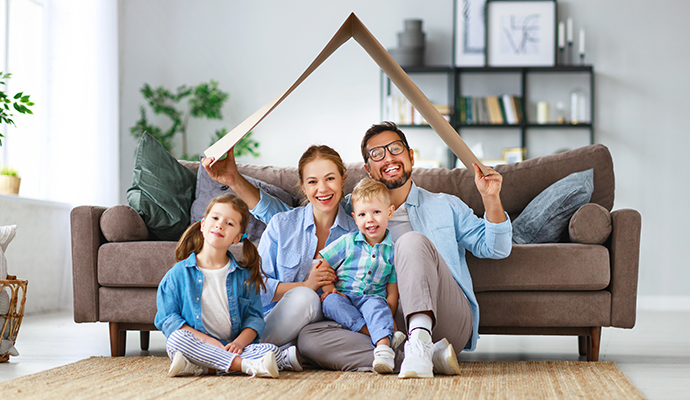 Happy family sitting inside living room