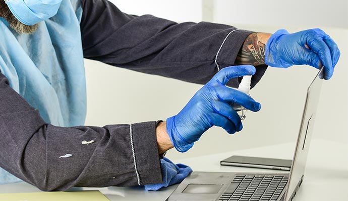 Professional cleaning and decontaminating a laptop during restoration