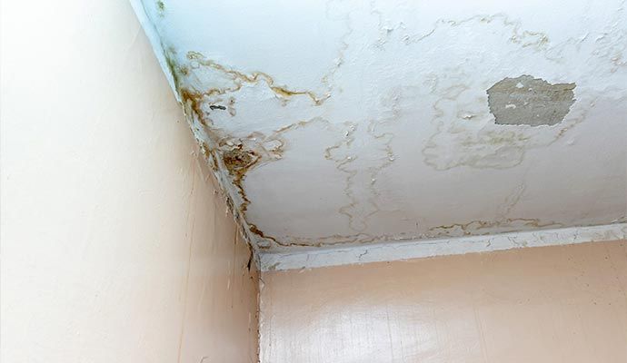 Ceiling with water stains and bubbling due to roof leak